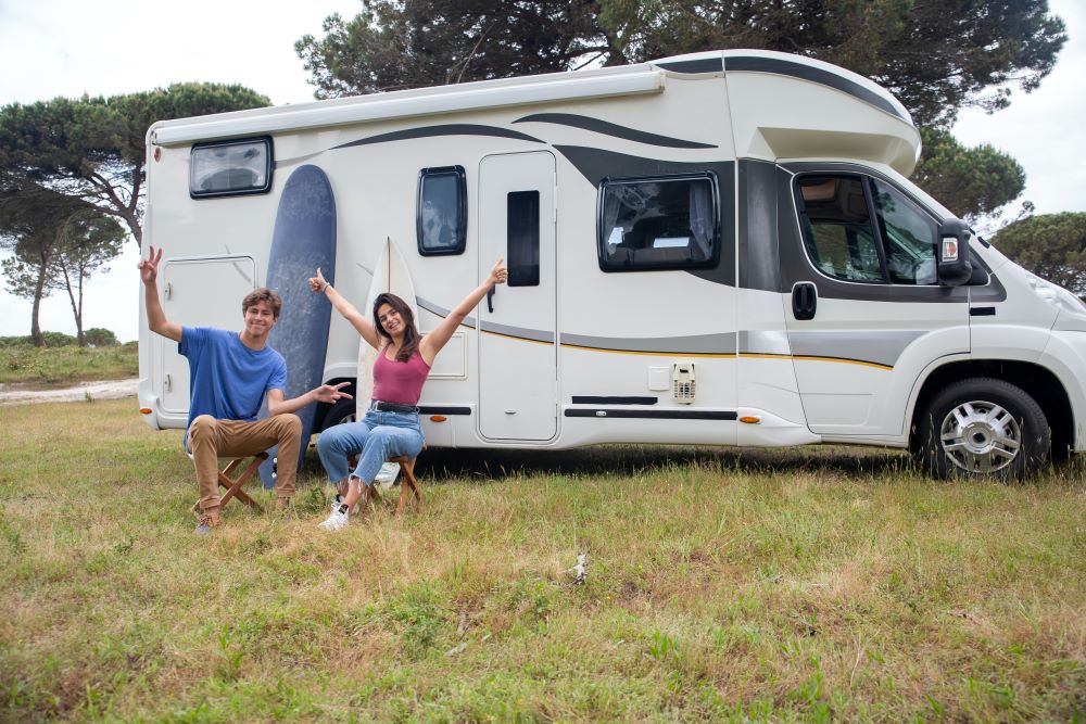 Couple sitting by an RV